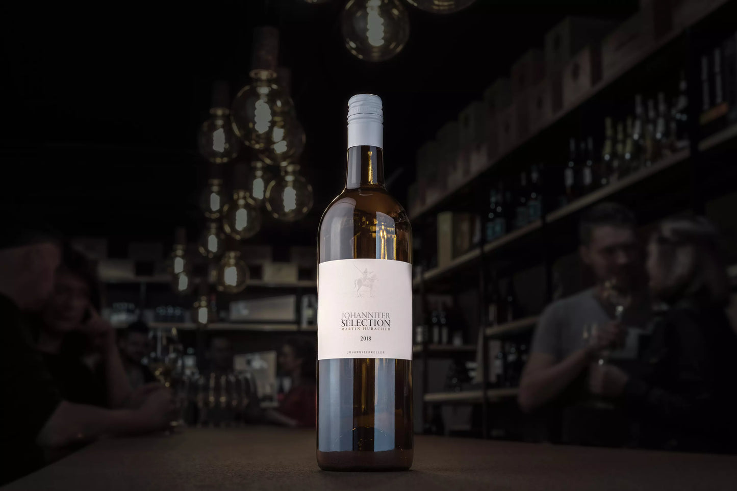 Johanniter Selection vom Johanniterkeller Martin Hubacher in der dunklen Vinothek auf dem Tisch.