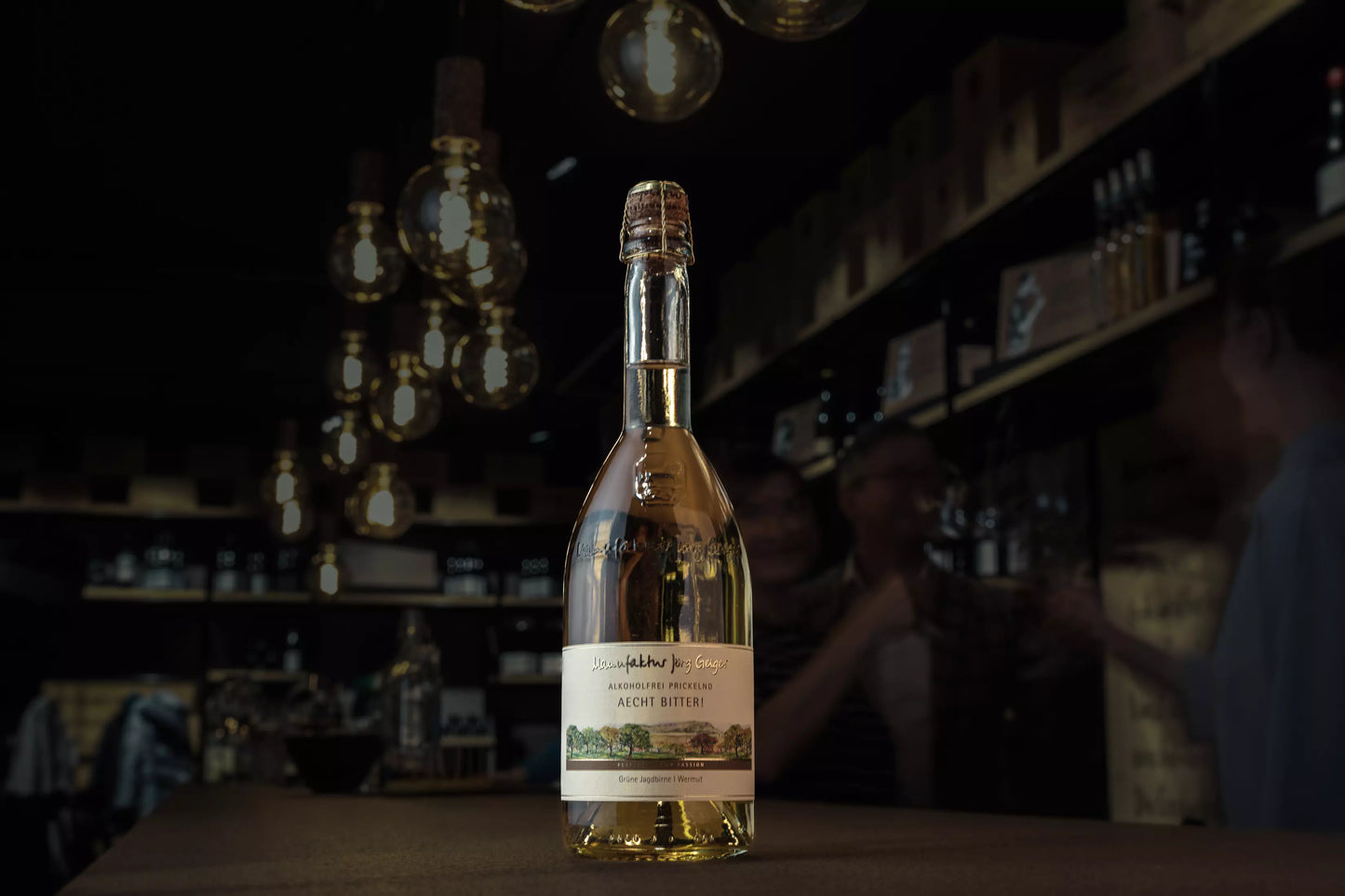 Aecht Bitter! von der Manufaktur Jörg Geiger auf dem Tisch in der Vinothek Hauser mit gedimmtem Licht.