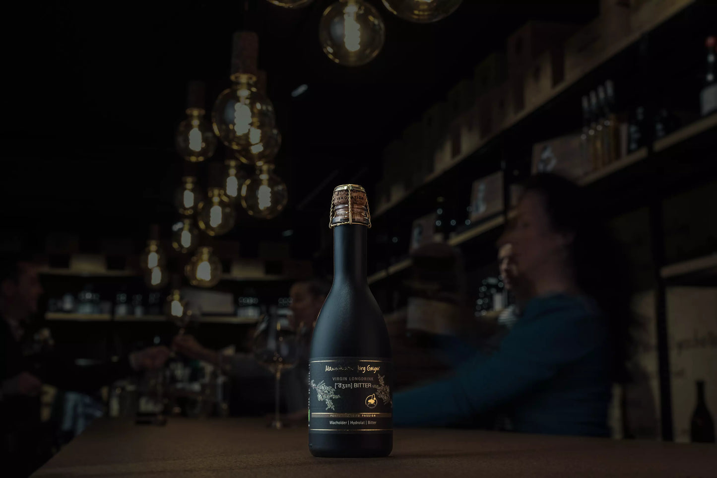 Bio Dzin Bitter von der Manufaktur Jörg Geiger auf dem Tisch in der Vinothek Hauser mit gedimmtem Licht.