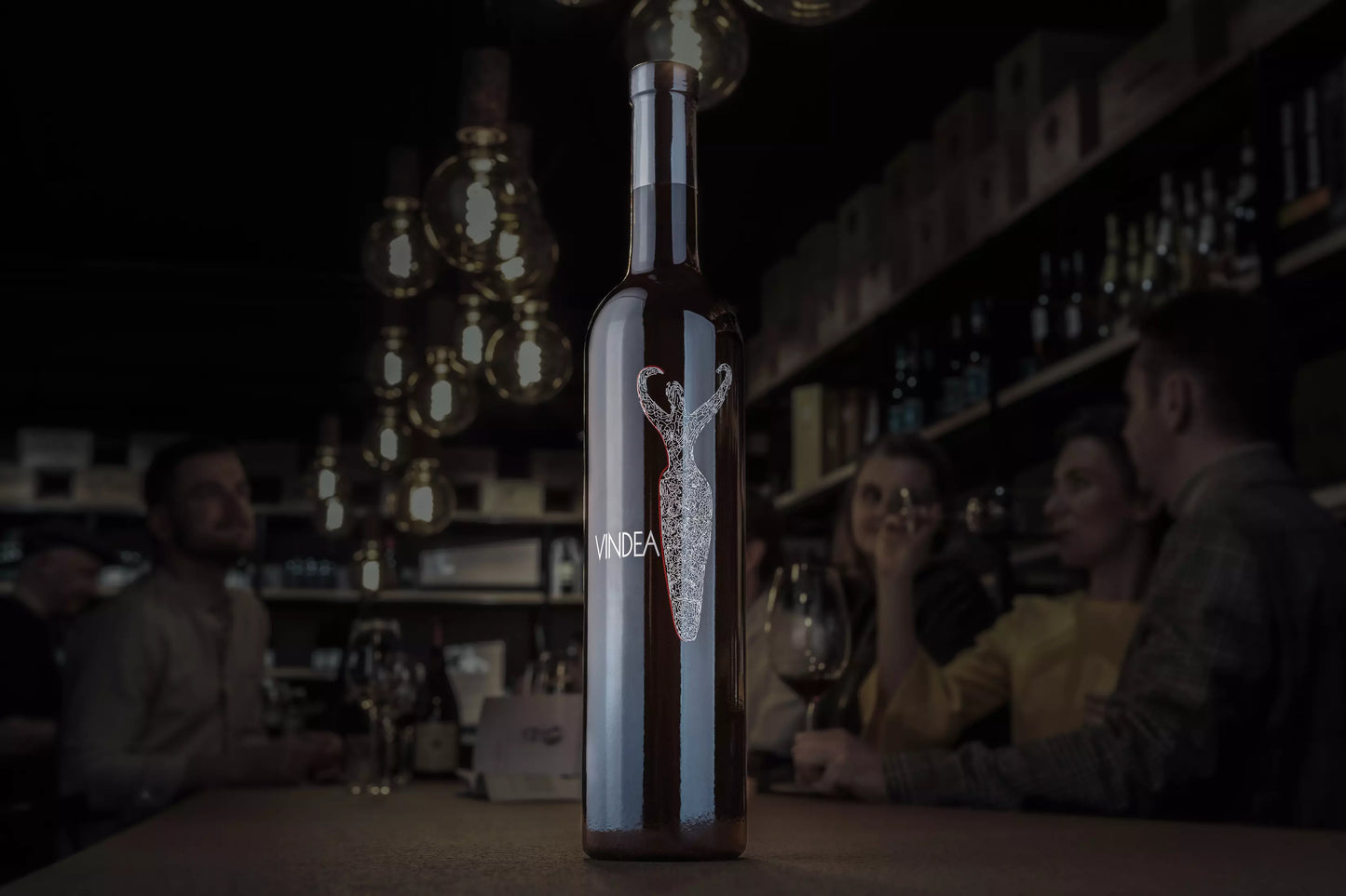 Flasche Vindea von Panzanello in der dunklen Vinothek Hauser auf dem Tisch.