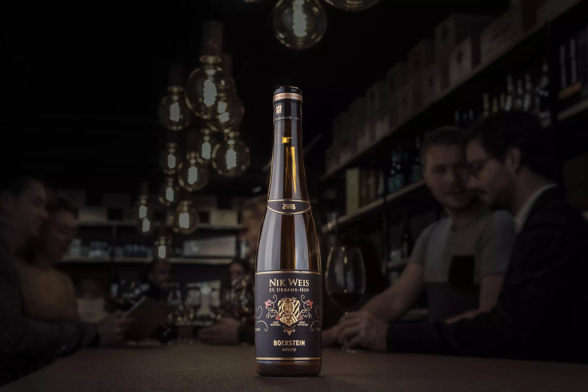 Bockstein Riesling Auslese VDP.Grosse Lage vom St. Urbanshof Nik Weis in der dunklen Vinothek Hauser auf dem Tisch.